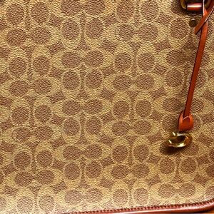 Coach large leather tote. Four gold feet to stand on. Middle zipper slot.